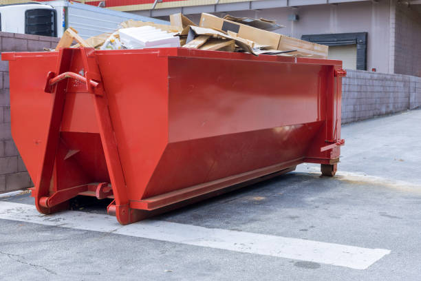Near construction site, there is dumpster loaded with construction waste debris